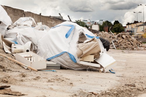 Worker operating a chipper safely with protective equipment